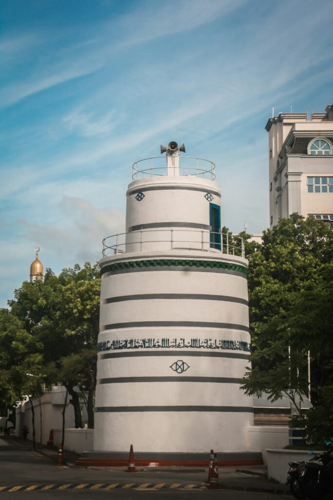 a white tower with a sign on it