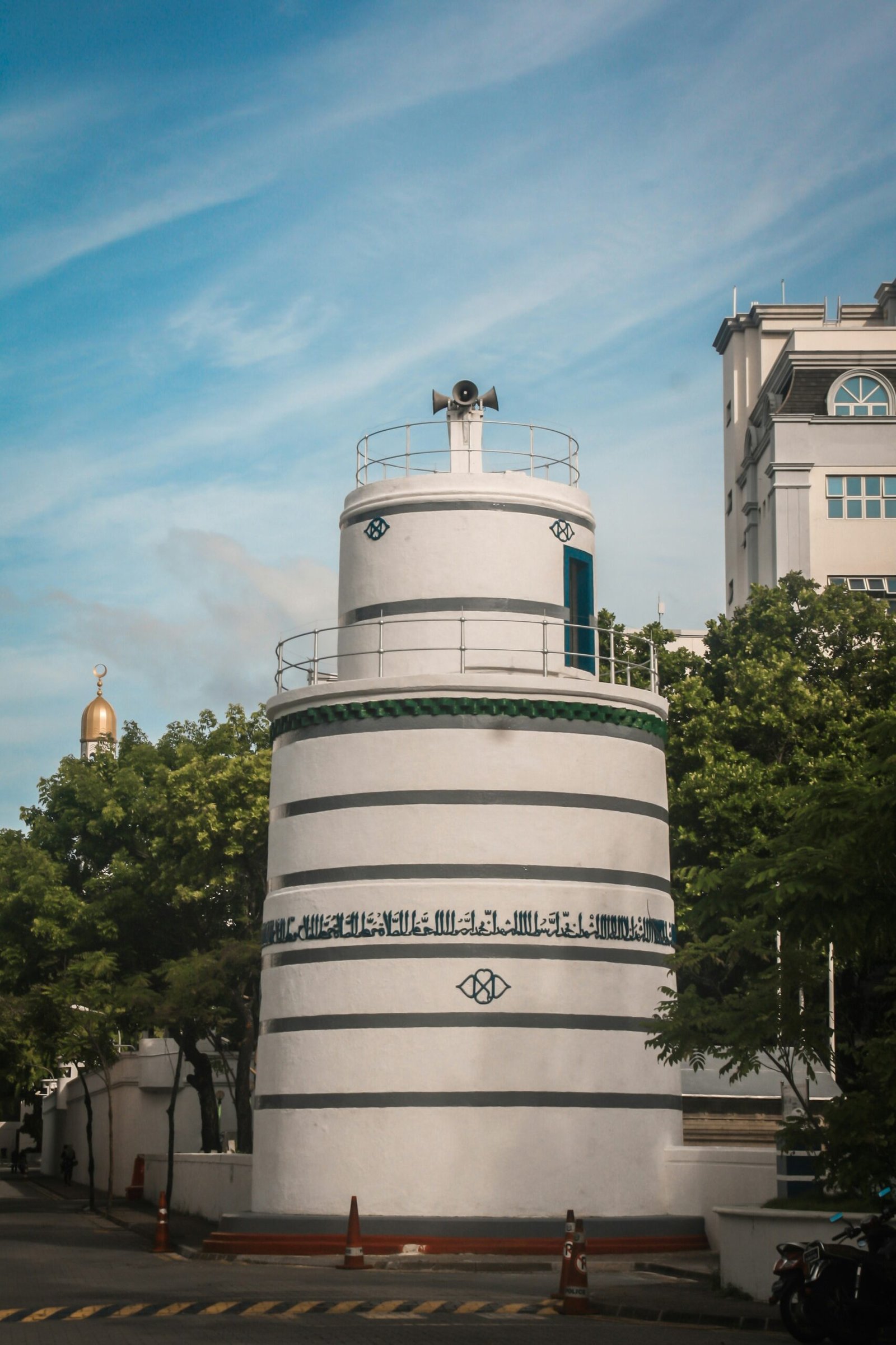 a white tower with a sign on it